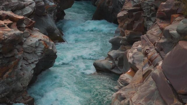 Blue colored Bagha river flowing in between gorge in the Himalayan mountain valley during the winter season at Keylong in Lahaul and Spiti district, Himachal Pradesh, India. River flowing between rock