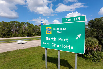 Interstate freeway exit sign in Florida, USA. I-75 highway interchange with direction to North Port...
