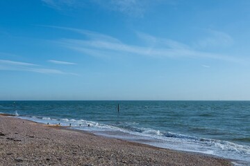 beautiful deserted beach at Selsey West Sussex England with blue sky in the background