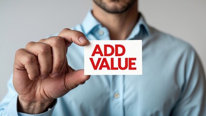 Hand of a man displaying a card with Add Value text - close-up shot against a white background.