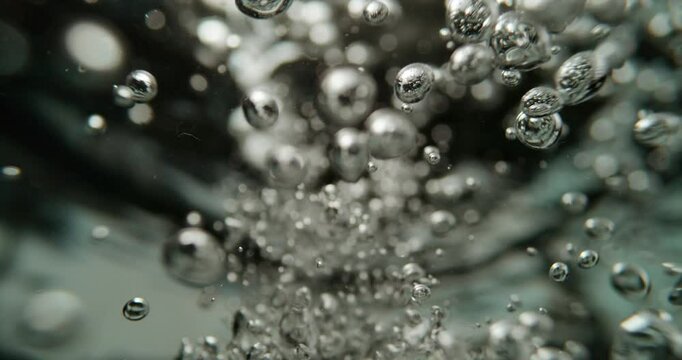 Slow motion shot of boiling water. Bubbles of boiling water background. Cooking concept