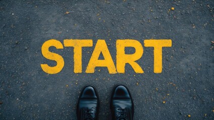 A set of feet on a pathway featuring a yellow print of the word start for the idea of a starting point.