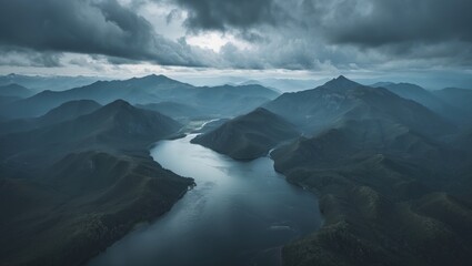 Obraz premium Aerial panoramic view of mountains, water, and vegetation.