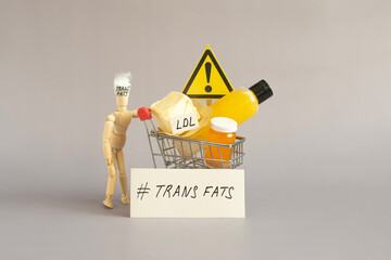 The idea of the dangers of foods containing large amounts of trans fats. The doll holds a basket with various trans fats and a warning sign.