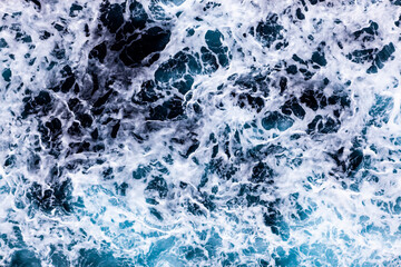 Sea water texture. Top view of awesome water with foam. Can be used in covers, packaging, posters, textures, cards, art and design projects. Creative nature background image.