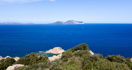 A scenic view from Capo Ceraso in Sardinia, Italy. Rocky coastline, turquoise sea, and lush...