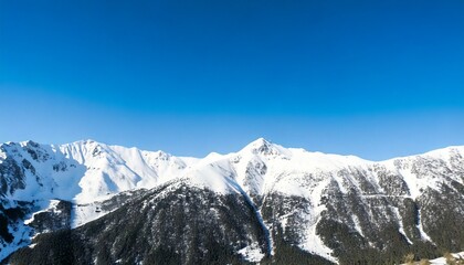 Obraz premium Photo of snowy mountain peaks with clear sky