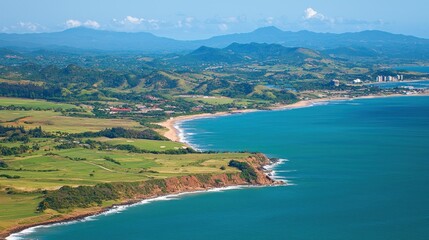 Naklejka premium Coastal vista, tropical hills, golf course, ocean waves, sunny day