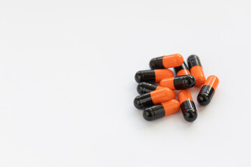 The pills are black and orange, enteric-soluble