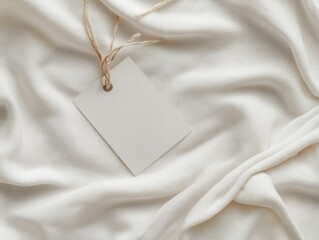 Blank price tag on draped ivory fabric