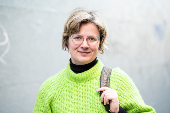 Portrait of a 38 yo white woman with blonde hair and a green sweater, Brussels, Belgium