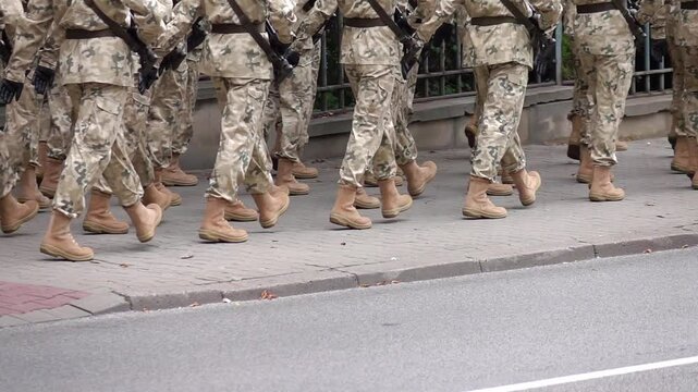 Soldiers marching on a sidewalk during a parade in slow motion 120fps