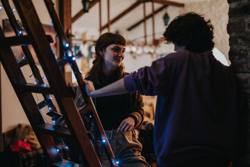 A couple of friends share a joyful and heartfelt moment in a warmly lit setting, enjoying each other's company amidst festive decorations and a relaxed atmosphere.