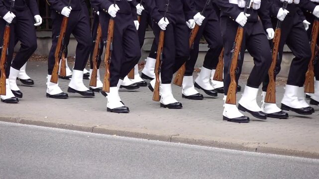 Navy soldiers marching on a sidewalk during a parade in slow motion 120fps
