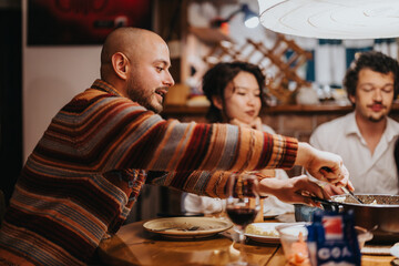 A cheerful group of friends sharing a meal at a cozy indoor table, surrounded by warm lighting and a convivial atmosphere. The image conveys friendship, togetherness, and comfortable enjoyment.