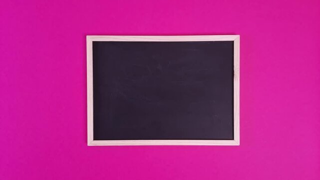 black chalkboard appears and disappears against pink background in stop-motion animation, template for text or messages for schools, teachers, educational content, busines. blank school chalkboard