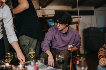 A group of friends enjoying a cozy indoor gathering, sharing drinks and engaging in casual discussions, creating a relaxed and friendly atmosphere filled with warmth and camaraderie.