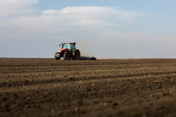 Tractor preparing the land for a new crop planting