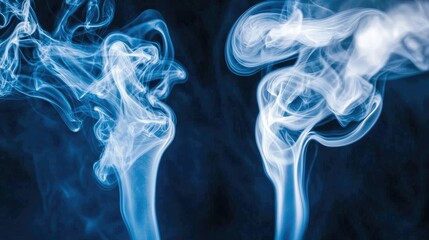 Abstract blue smoke swirls on black background; design element