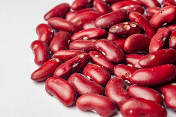 A close-up studio shot showcases the vibrant color and texture of raw red kidney beans.