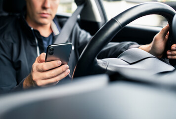Driving distracted by phone. Car driver texting. Accident and crash danger. Man using mobile cellphone while on road. Irresponsible guy using text sms. No safety. Rideshare app in smartphone.