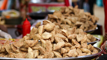 Selective focus of Indonesian Food, Bakso Goreng (Deep Fried Meat Balls). The shape look like flower. Served with Chili sauce.
