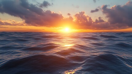 Obraz premium A serene sunset over the ocean, casting warm hues across gentle waves.