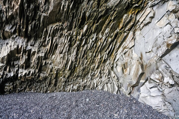 Basalt rock formations creating a natural shelter on a black sand beach in iceland