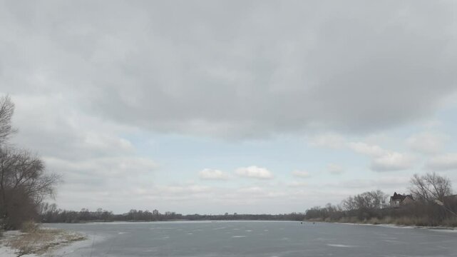 slow motion video winter landscape on frozen lake. cracked ice on river. Bird watching in the wild. Slow motion video in 4k. Hand held video of lake shore frost winter cold wether