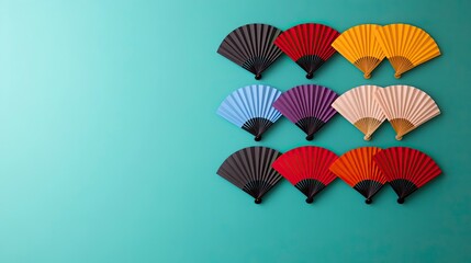 Colorful paper fans arranged in rows on a teal background.