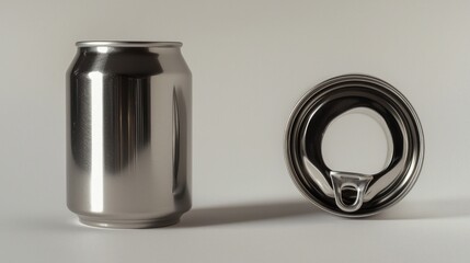 Studio shot of a metallic can and its open lid, showcasing design elements