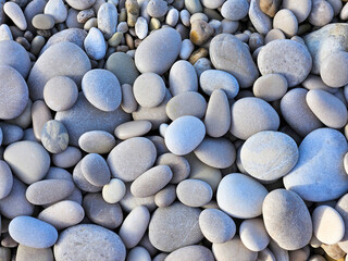 Processed collage of sea shore pebbles texture.
