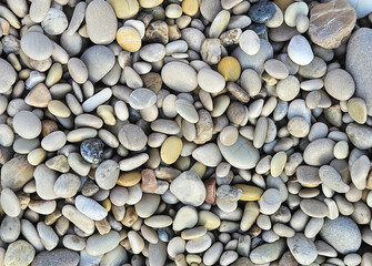 Processed collage of sea shore pebbles texture.