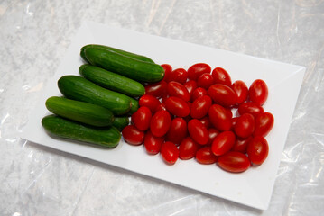 tomatoes and cucumbers on a white plate