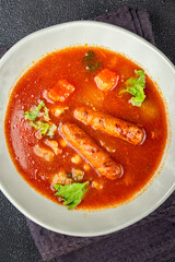 Tomato soup with sausages fresh tasty food dish delicious gourmet food background on the table rustic food top view copy space