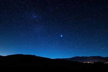 Breathtaking night sky full of stars illuminating a mountain silhouette, with shooting stars adding magic to the scene