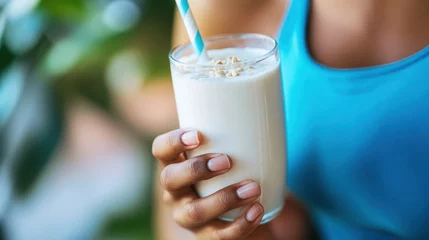 Fototapete Rund A person drinks a protein shake after a workout.  © Ulia_photo