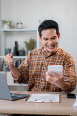 Smiling startup founder calculating business success with digital tool near laptop