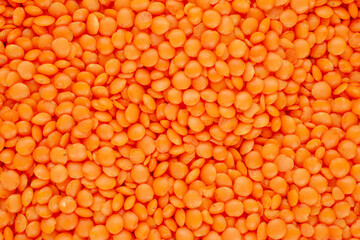 Red raw lentils, macro, top view.
