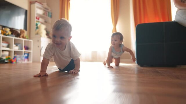 First steps. baby is crawling on the floor of an indoors bathroom. Cute kid infant family dream concept. group of baby are crawling around and playing. A group of baby are playing fun and crawling.