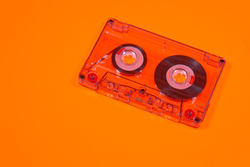 Retro audio cassettes on orange background