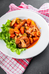 Ragout meat, sausages, vegetables stew dish fresh tasty food delicious gourmet food background on the table rustic food top view copy space