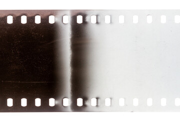 Dusty and grungy 35mm film texture or surface. Perforated scratched camera film isolated on white...
