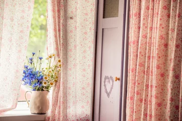 room interior in old vintage Provence style. old cabinet with cute zanaevskis and a bouquet of daisies and cornflowers on the window