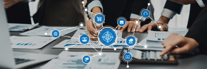 Professionals engage in a collaborative project in an office, surrounded by charts and digital icons, symbolizing modern technology and teamwork for innovative solutions. Amity