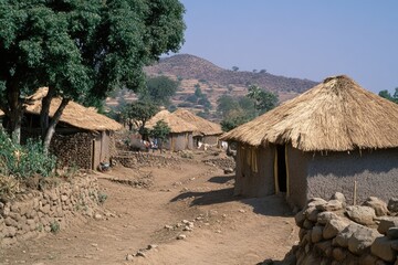 Eritrean Village Scene: A Vibrant View of Life in the Western Region, Highlighting Clay Homes and Thatched Roofs Amidst Challenges of Poverty