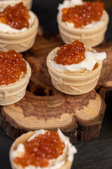 a quick snack from a waffle cup with buttercream and natural red caviar