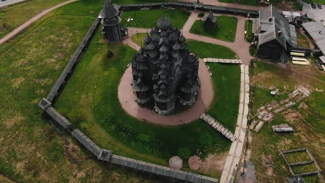 Aerial footage revealing intricate wooden architecture of unesco world heritage site church of transfiguration on kizhi island, karelia, russia