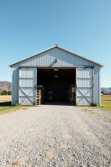 Rustic Metal Storage Building with Open Doors Revealing Stacked Pallets Inside on a Sunny Day