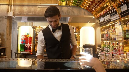 Serving special drink gin fizz of mixed cocktail to smiling VIP customer with couple or friend group by smart bartender service at beverage counter bar luxury nightlife at nightclub party. Vinosity.
